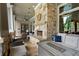 Covered outdoor lounge area with stone fireplace, comfortable seating, and stylish decor at 756 Stickley Oak Way, Woodstock, GA 30189