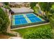 Aerial view of well-maintained pickleball courts surrounded by lush landscaping in a community at 756 Stickley Oak Way, Woodstock, GA 30189