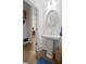 Chic powder room with stylish pedestal sink, modern lighting, and elegant mirror at 756 Stickley Oak Way, Woodstock, GA 30189