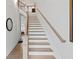 Elegant staircase with wooden banister, hardwood floors, and bright natural light at 756 Stickley Oak Way, Woodstock, GA 30189