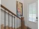 Light-filled foyer and staircase featuring hardwood floors, decorative art, and a window at 756 Stickley Oak Way, Woodstock, GA 30189