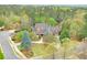 A beautiful two-story home surrounded by lush green trees and a well-manicured lawn at 800 Flathead Pass, Suwanee, GA 30024
