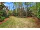 Well-maintained backyard with manicured lawn and mature trees offering privacy and serenity at 800 Flathead Pass, Suwanee, GA 30024