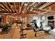 Unfinished basement with exposed wood ceiling and exercise equipment at 800 Flathead Pass, Suwanee, GA 30024