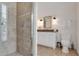 Bathroom showcasing a glass-enclosed shower with tiled walls and a vanity with granite countertops at 800 Flathead Pass, Suwanee, GA 30024