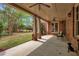 Covered patio features stone columns, ceiling fans, and a view of the lush backyard at 800 Flathead Pass, Suwanee, GA 30024