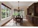 Elegant dining room with ample natural light from large windows and beautiful built-in cabinetry at 800 Flathead Pass, Suwanee, GA 30024