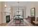Formal dining room features a fireplace, chandelier, and large windows for an elegant dining experience at 800 Flathead Pass, Suwanee, GA 30024