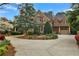 Beautiful home with brick and stone exterior, mature landscaping, and a circular driveway at 800 Flathead Pass, Suwanee, GA 30024