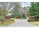 Charming home with brick driveway, lush landscaping, and mature trees at 800 Flathead Pass, Suwanee, GA 30024