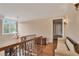 Elegant hallway with hardwood floors, detailed trim, chandelier, and lots of natural light from the large window at 800 Flathead Pass, Suwanee, GA 30024