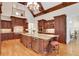 Gourmet kitchen with granite countertops, a large island, custom cabinetry, and modern stainless appliances at 800 Flathead Pass, Suwanee, GA 30024
