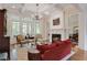 Bright living room boasts a fireplace, large windows, and elegant furnishings for comfortable living at 800 Flathead Pass, Suwanee, GA 30024