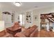 Living room with leather furniture, built-in shelving, and a view of the upper landing at 800 Flathead Pass, Suwanee, GA 30024