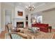 Cozy living room with fireplace, classic furniture, and natural light creates an inviting atmosphere at 800 Flathead Pass, Suwanee, GA 30024
