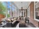 Bright sunroom with brick accents, large windows, and comfortable seating, perfect for relaxation at 800 Flathead Pass, Suwanee, GA 30024