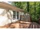 Charming back deck featuring wooden planks, a railing, and a tranquil view of the surrounding wooded area at 4704 Apache Sw Trl, Atlanta, GA 30331