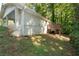 Back exterior with deck, covered patio, and views of the tree-filled backyard at 4704 Apache Sw Trl, Atlanta, GA 30331