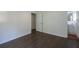 Small bedroom leads into a bathroom with white walls and hardwood floors at 4704 Apache Sw Trl, Atlanta, GA 30331