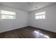 Bright bedroom with hardwood floors and two windows allowing ample light at 4704 Apache Sw Trl, Atlanta, GA 30331