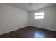 A modest bedroom with sleek, dark hardwood floors and a bright window at 4704 Apache Sw Trl, Atlanta, GA 30331
