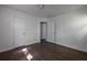 Well-lit bedroom with sleek hardwood floors and neutral walls at 4704 Apache Sw Trl, Atlanta, GA 30331