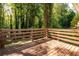 A sun-drenched wood deck surrounded by lush green trees offers a tranquil outdoor space at 4704 Apache Sw Trl, Atlanta, GA 30331