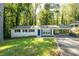 Charming single-story home featuring a covered carport, freshly painted exterior, and a well-manicured lawn at 4704 Apache Sw Trl, Atlanta, GA 30331