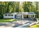 Inviting home featuring a carport, neatly manicured lawn, and charming curb appeal at 4704 Apache Sw Trl, Atlanta, GA 30331