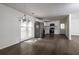 Spacious kitchen area with stainless steel appliances, hardwood floors, and a dining area with modern chandelier at 4704 Apache Sw Trl, Atlanta, GA 30331