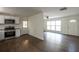 Bright open space with hardwood floors that transitions into a kitchen area featuring stainless steel appliances at 4704 Apache Sw Trl, Atlanta, GA 30331