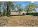 View of the home's backyard, featuring a green wooden fence and sparse foliage at 4980 W Chapel Hill Rd, Douglasville, GA 30135