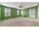 Bedroom featuring two windows, a ceiling fan, carpet floors, and an exterior door at 4980 W Chapel Hill Rd, Douglasville, GA 30135