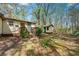 Exterior view of home showing the front yard with grass, plants, and a shed at 4980 W Chapel Hill Rd, Douglasville, GA 30135