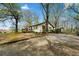 Charming one-story home with light siding, wood accents, mature trees, and a spacious yard at 4980 W Chapel Hill Rd, Douglasville, GA 30135