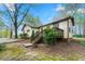 Exterior view of the house with a green lawn and shrubbery, a wooden porch, and a shed at 4980 W Chapel Hill Rd, Douglasville, GA 30135