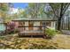 Welcoming front porch with wood railing and blooming shrubs, perfect for enjoying the outdoors at 4980 W Chapel Hill Rd, Douglasville, GA 30135