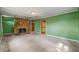 Spacious living area with a unique stone fireplace, green walls and access to other rooms at 4980 W Chapel Hill Rd, Douglasville, GA 30135