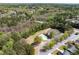 Aerial view of a neighborhood pool and clubhouse, surrounded by lush greenery and trees at 1545 Heatherton Rd, Dacula, GA 30019