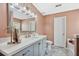 Light filled bathroom with a large vanity and drawers, and stylish gray marble-look floors at 1545 Heatherton Rd, Dacula, GA 30019