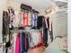 Walk in closet features extensive shelving for storing clothes and luggage at 1545 Heatherton Rd, Dacula, GA 30019