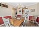 Cozy dining room featuring an elegant chandelier, wood floors, and a large window at 1545 Heatherton Rd, Dacula, GA 30019
