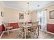 Cozy dining room featuring an elegant chandelier, wood floors, and a large window at 1545 Heatherton Rd, Dacula, GA 30019