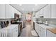 Galley-style kitchen with white cabinets, stainless appliances, and an open layout connecting to the dining area at 1545 Heatherton Rd, Dacula, GA 30019