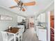 Galley kitchen features white cabinets, stainless appliances, and a dining table for cozy meals at 1545 Heatherton Rd, Dacula, GA 30019