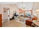 Comfortable living room featuring a fireplace, high ceilings, wood flooring and lots of natural light at 1545 Heatherton Rd, Dacula, GA 30019