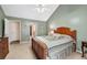 Relaxing main bedroom featuring neutral paint, vaulted ceiling and carpeted floor at 1545 Heatherton Rd, Dacula, GA 30019