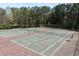 Outdoor tennis courts surrounded by lush greenery offer an active lifestyle and community engagement at 1545 Heatherton Rd, Dacula, GA 30019