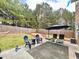 This outdoor space includes a patio with seating, a lush lawn, and mature trees and landscaping at 2240 Arnold Mill Nw Rd, Lawrenceville, GA 30044