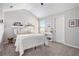 Neutral bedroom featuring a comfortable bed, natural light, and tasteful decor at 2240 Arnold Mill Nw Rd, Lawrenceville, GA 30044